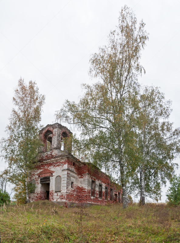 Ruins of old сhurch with ancient tomb and cross before