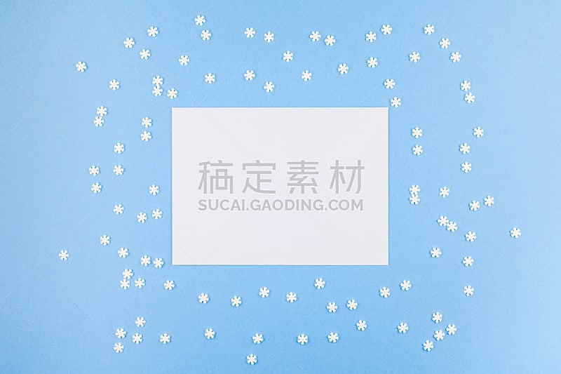 Creative Top view flat lay winter frame. Сoncept Mockup pattern made of small white snowflakes letter envelope pastel blue background copy space minimalism Template anniversary design invitation cards