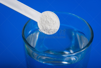 Sport supplement, creatine, hmb, bcaa, amino acid or vitamin - mesure with powder over a glass of water. Sport nutrition concept.
