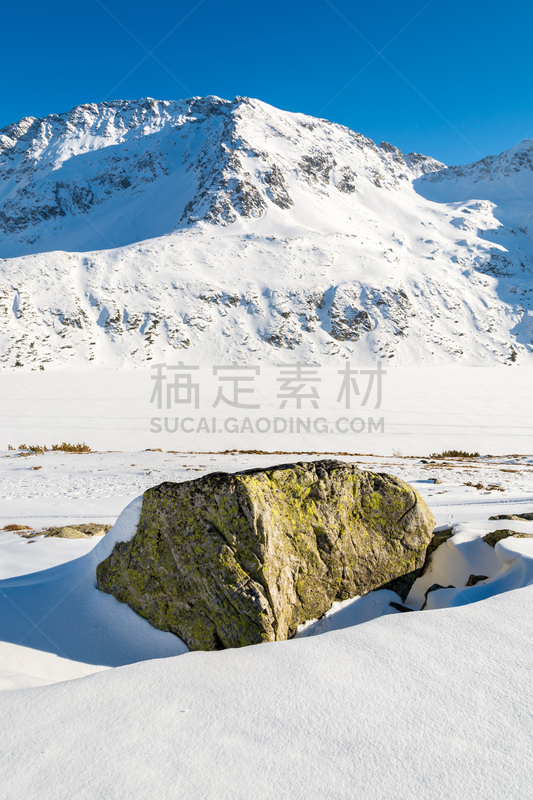 View of mountains covered with snow in five lakes valley from trail to Kozi Wierch peak, High Tatra Mountains, Poland