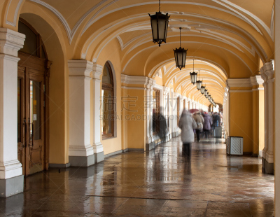 Architecture photo from Saint-Petersburg (Russia): passage (arcade, gallery) in a mall GOSTINYI DVOR crowded by people silhouettes by a wet winter weather.