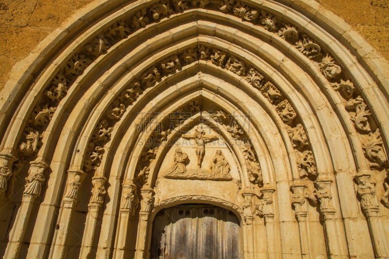 Lintel of the west gate of the Monastery of Sandoval, decorated with figures (Christ, Virgin and child, praying monk kneeling) and floral motifs carved in stone. Monastery, Cistercian of the twelfth century Santa Maria de Sandoval. Leon. Spain - Puerta oe