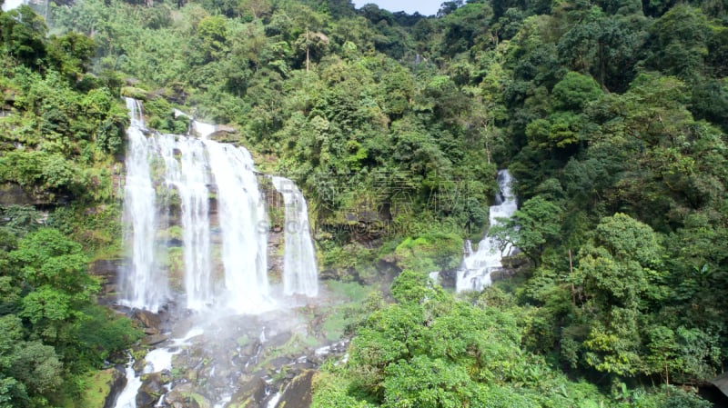 Beautiful waterfall.Tad Khamued Waterfall in southern Laos.It is a place to visit the natural beauty.Mountain forest fall landscape.Top view,Aerial view,amazing nature background,Rainforest