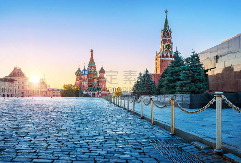 St. Basil’s Cathedral and the Spasskaya Tower on Red Square in Moscow and pigeons on an early autumn sunny morning