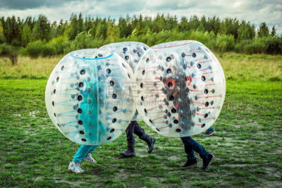 Bumperball. Teens play bumper-ball outdoor