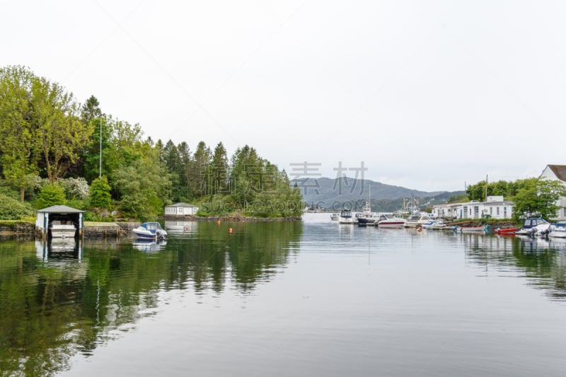 Boats moored in the water in charming Alvøen, one of the oldest industrial communities in Norway.