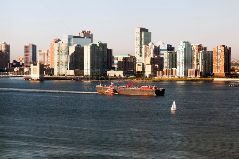 A big tanker passing by Hudson river and New Jersey skyline