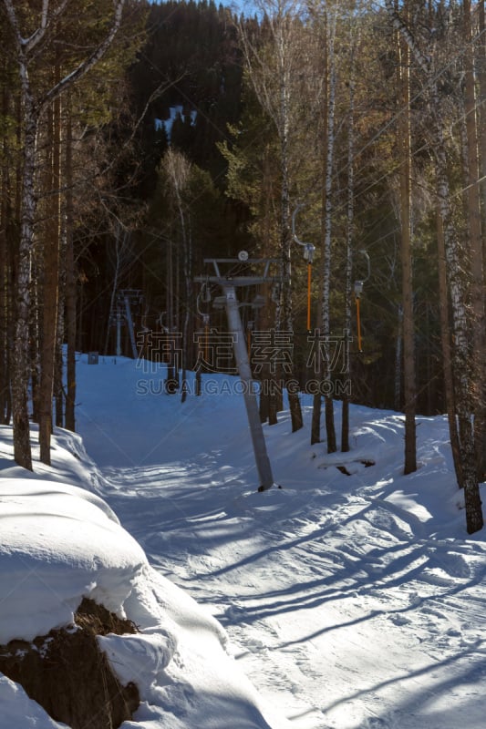 ski lift in the mountains through the woods