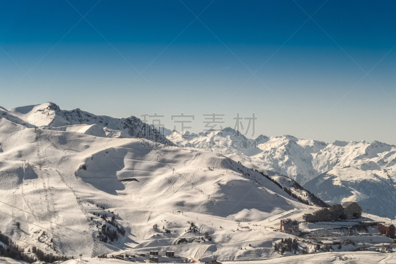 Skiing  and snowboarding in the mountain slopes  of ski resort  Les arcs-La Plagne.