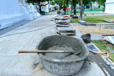Cement mixing with salver at construction site.