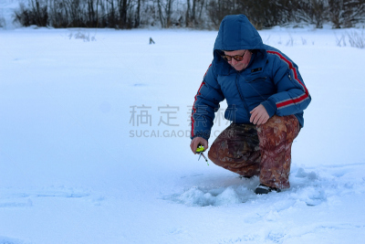 Winter season old man fishing on lake