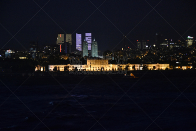 Istanbul city at night by bosphorus and Dolmabahce Palace in the background