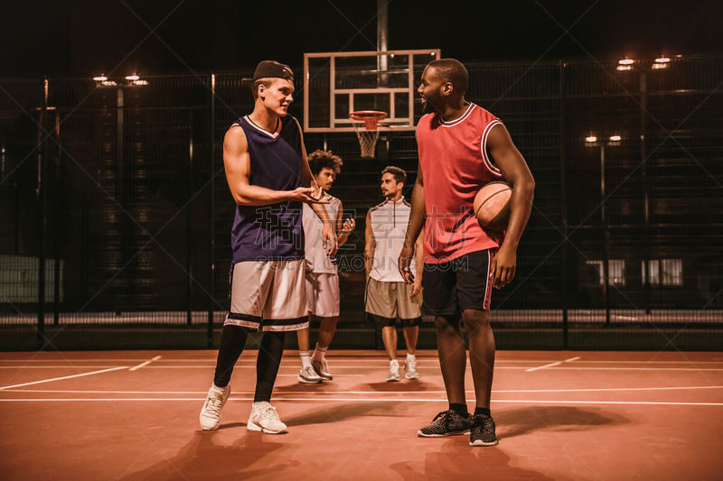 Guys playing basketball