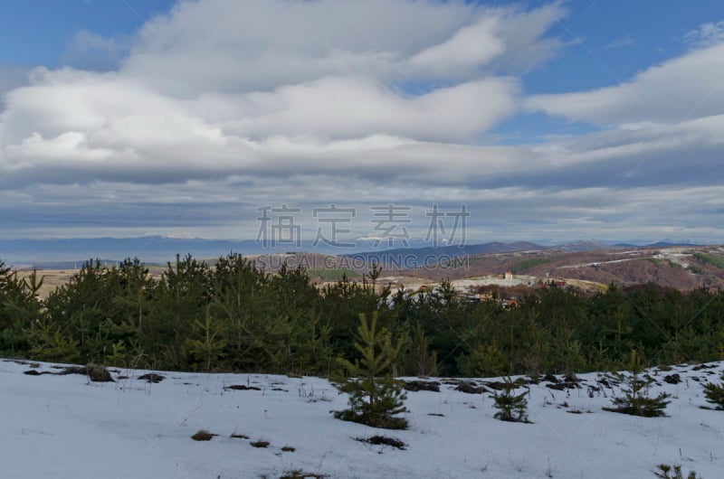 Majestic view of cloudy sky, winter mountain, snowy glade, residential district, conifer and deciduous forest   from Plana mountain toward Balkan mountain or Stara planina