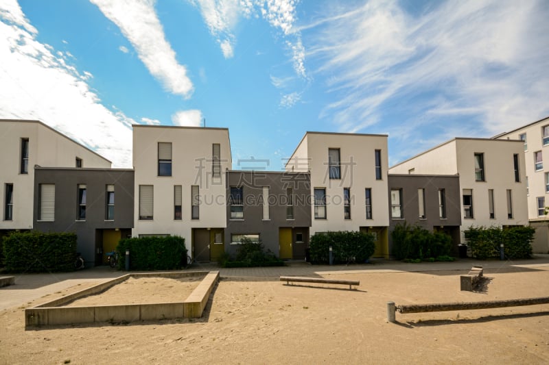 Modern townhouses in a residential area, new apartment buildings with green outdoor facilities in the city