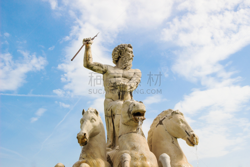 Roman statue,  White Marble man statue with three horses, in garden in blue sky background.