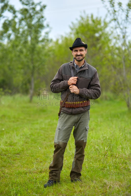 Hunter with shotgun in the forest