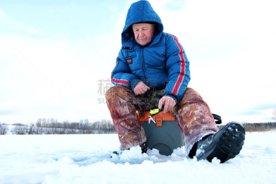 Winter season old man fishing on lake