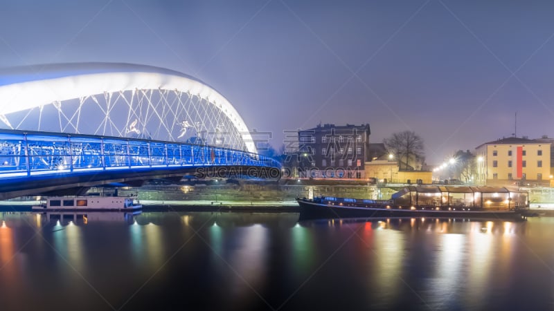 Father Bernatek Footbridge straddles the Wisła River just south of the centre, linking the two Jewish districts Kazimierz and Podgórze in Cracow, Poland.