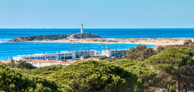 Panoramic view of the Caños de Meca, with the Trafalgar lighthouse in the background, in a photo taken from the pine forest of La Breña, Barbate, Spain, Europe