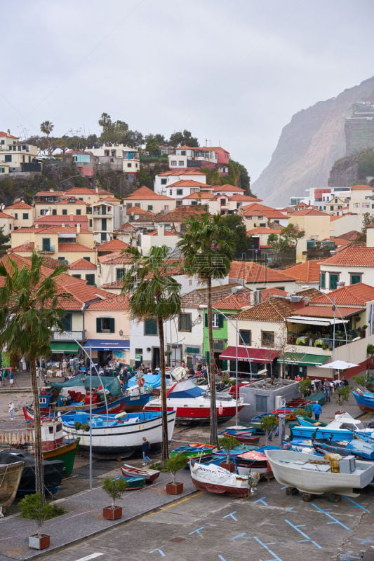 View of Câmara de Lobos in Madeira with Cape Girão on the background and boats at the marina