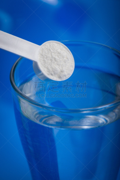 Sport supplement, creatine, hmb, bcaa, amino acid or vitamin - mesure with powder over a glass of water. Sport nutrition concept.