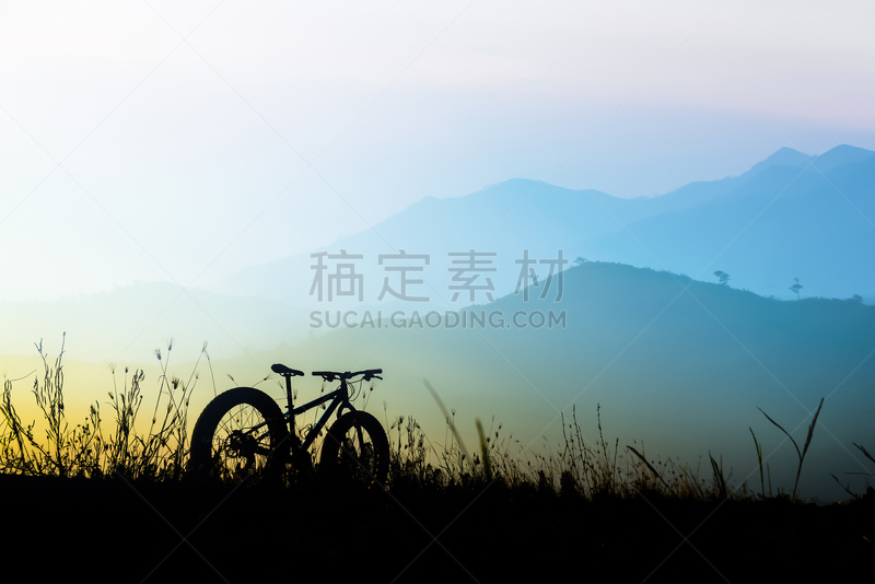 beautiful sunset sky and mountain bike silhouette , silhouette fat bike