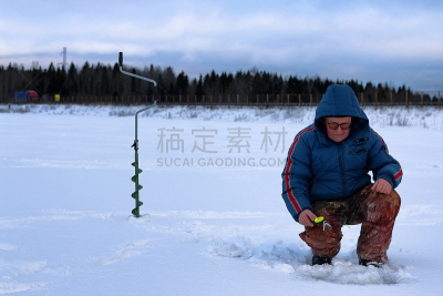 Winter season old man fishing on lake