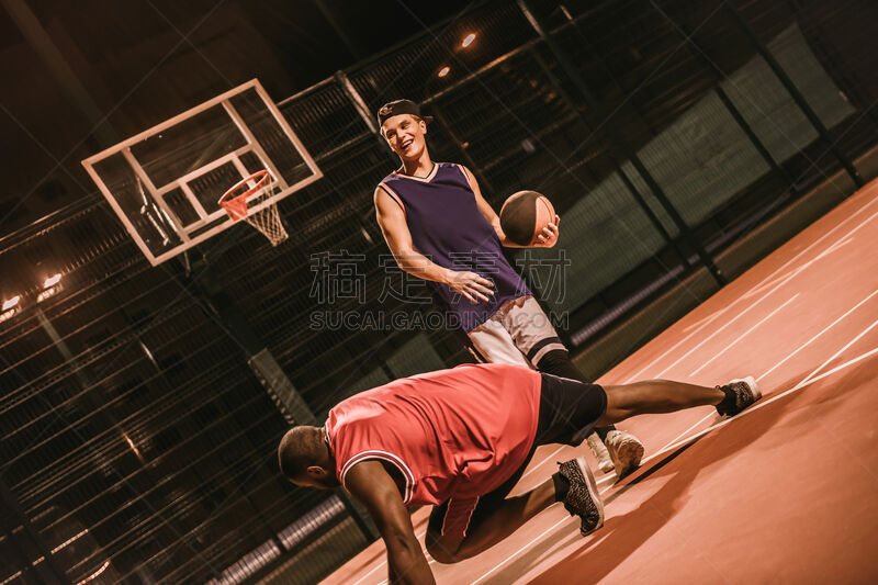 Guys playing basketball