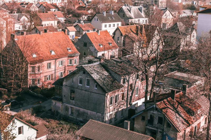 urban texture background of red tiled roofs of houses in old city in Europe, view of vintage houses with tile roofs in old town.