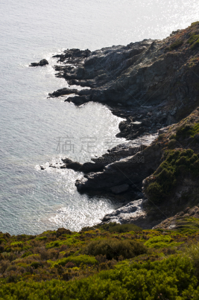 Corsica: cliffs and Mediterranean maquis at Anse d’Aliso (Plage d’Alisu), one of the most remote beaches of the western side of Cap Corse