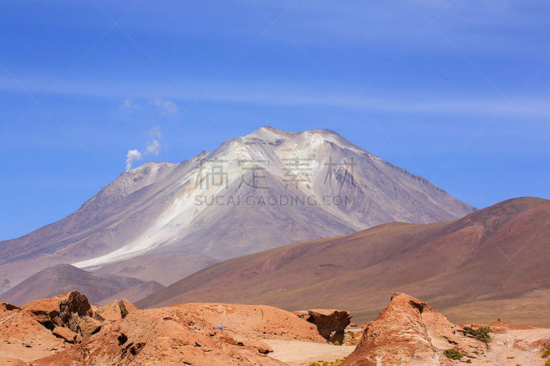 Ollagüe volcano, still active, seen from the high plateau of the Siloli Desert, near the Salar de Uyuni (Uyuni Salt Falt) and the border with Chile, in southwestern Bolivia. The Siloli desert runs along the border with Chile. It is famous for its rock for