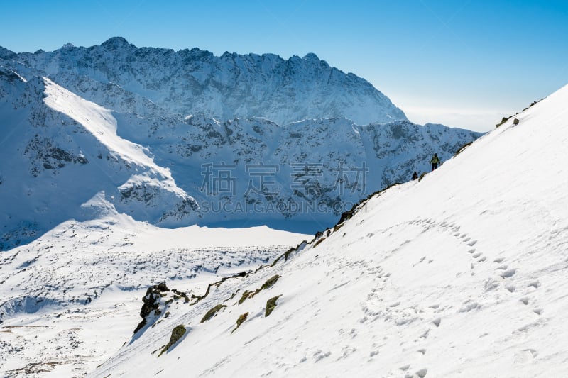 View of mountains covered with snow in five lakes valley from trail to Kozi Wierch peak, High Tatra Mountains, Poland