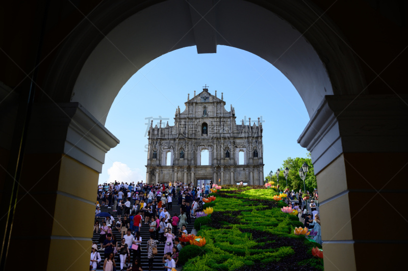 Ruin of St Paul, Macau - December 2019 : Too many people are coming to visit the Ruin of St Paul gate, which is the most famous landmark of Macau. Perspective view from the main shopping street.