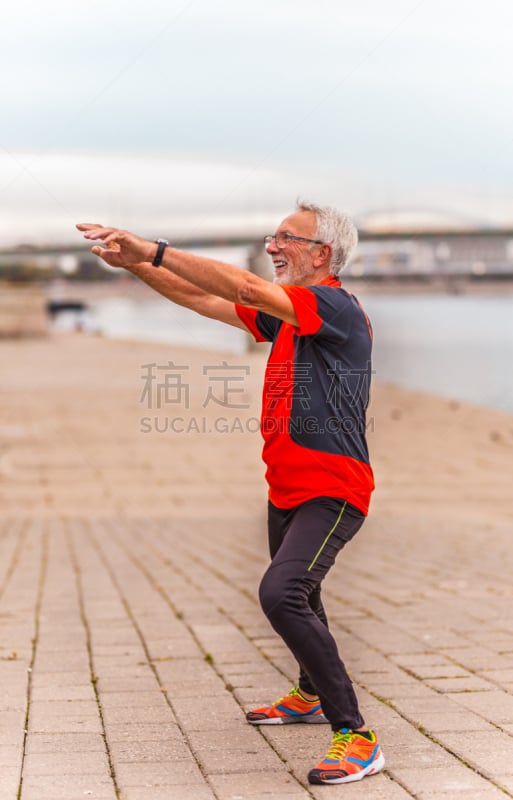 Senior man stretching outdoors