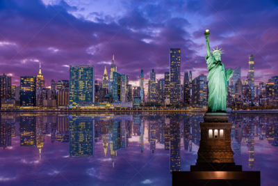 Statue of Liberty and New York City Skyline with UN Building, Chrysler Building and Empire State Building, Reflected in East River at Sunset.