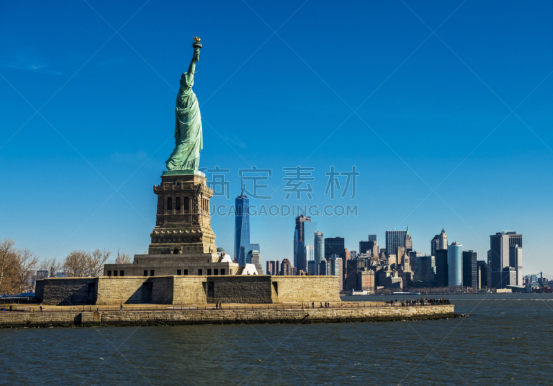 Statue of Liberty with Lower Manhattan skyline in New York City through Hudson River