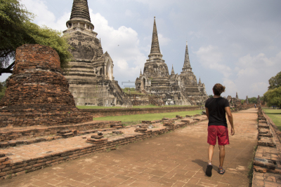 one man, with man bun, visiting the ancient ruins of Wat Phra Si SanphetAyutthaya, Thailand