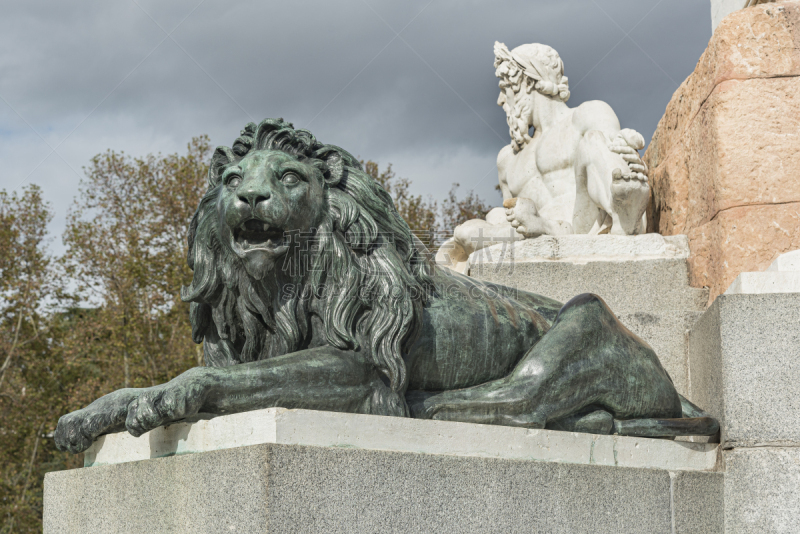 Madrid, Spain – Sept 26, 2019: Bronze statue of a lion from year 1843. Statue of king was produced by the Italian sculptor Pietro Tacca