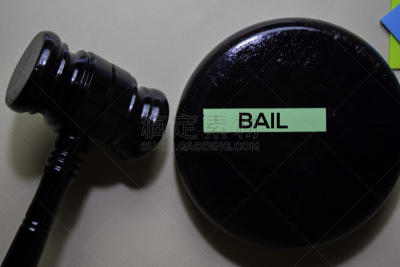 BAIL text on sticky notes and gavel isolated on office desk. Justice law concept