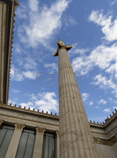 The building of the Athens Academy a marble column with a sculptures of Apollo and Athena, Socrates and Plato against a with clouds in Athens, Greece