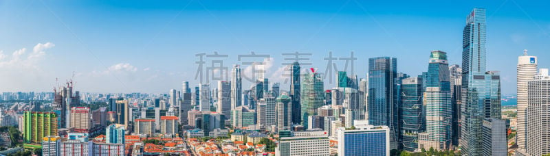 Panoramic vista across the crowded skyscraper cityscape of Singapore’s Downtown Core overlooking Chinatown, Marina Bay and the ocean harbour port.