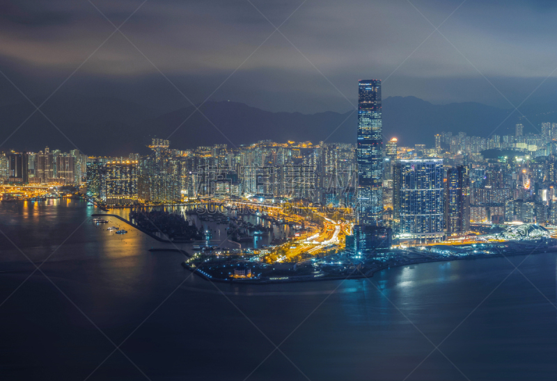 Aerial view of Hong Kong Downtown and Victoria Harbour. Financial district and business centers in smart city, technology concept. skyscraper and high-rise buildings at night.