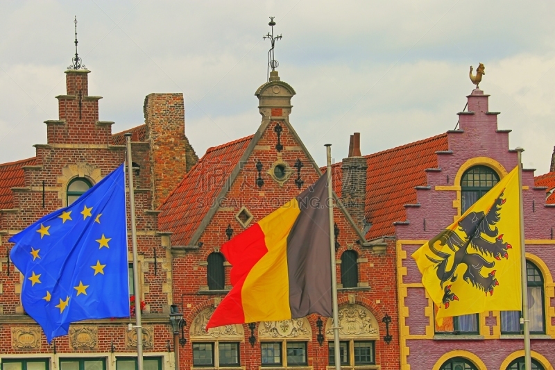 Belgian and Euro flags waving in market town - medieval old town - Belgium