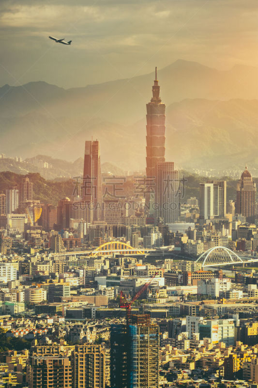 Sunset of Taipei Downtown with  an airplane taking off from Songshan airport