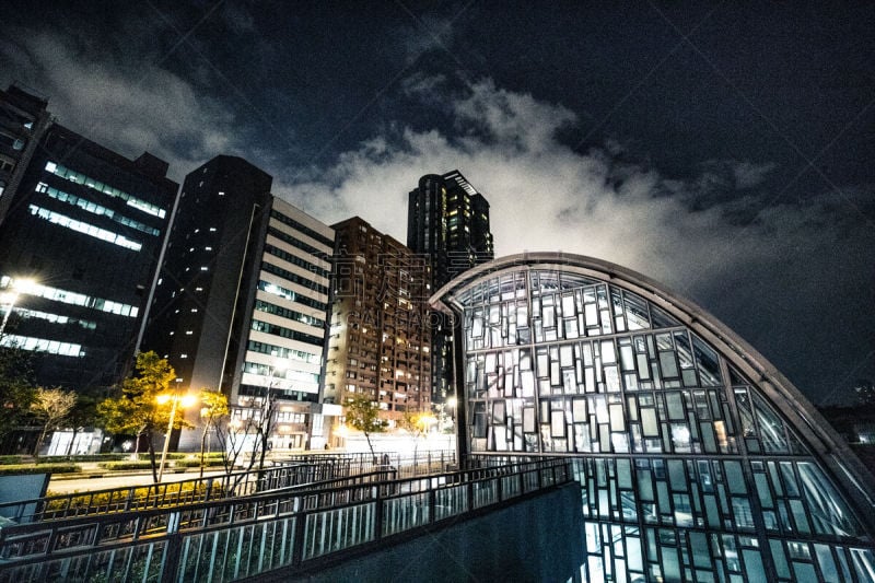 Taiwan - Taipei: entrance of the subway station and financial district buildings at night at Daan Park