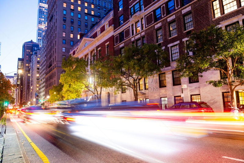 This is a long exposure photograph motion blurring traffic on Park Avenue in Manhattan’s Upper East of New York City at night.