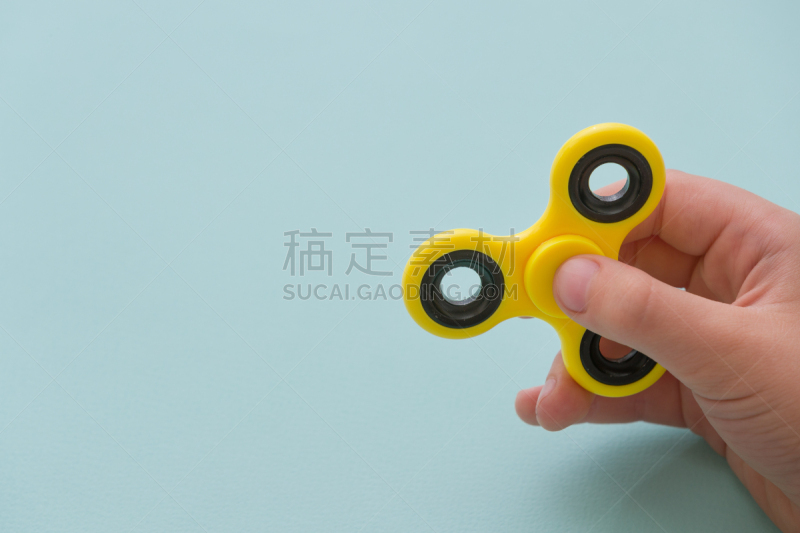玩具,童年,黄色,手,进行中,蓝色背景,指尖陀螺,走神,旋转