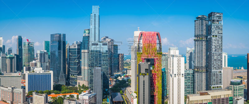 Panoramic vista across the crowded skyscraper cityscape of Singapore’s Downtown Core overlooking Chinatown, Marina Bay and the ocean harbour port.