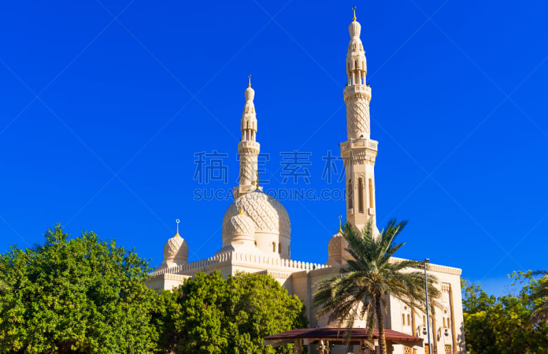 View of the facade of the building of the mosque Jumeirah, Dubai, United Arab Emirates. Isolated on blue background